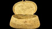 An oval basket, tapering out the base, with a lid but no handle.